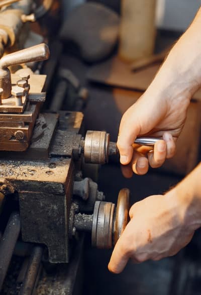 a man working on machine with both hand