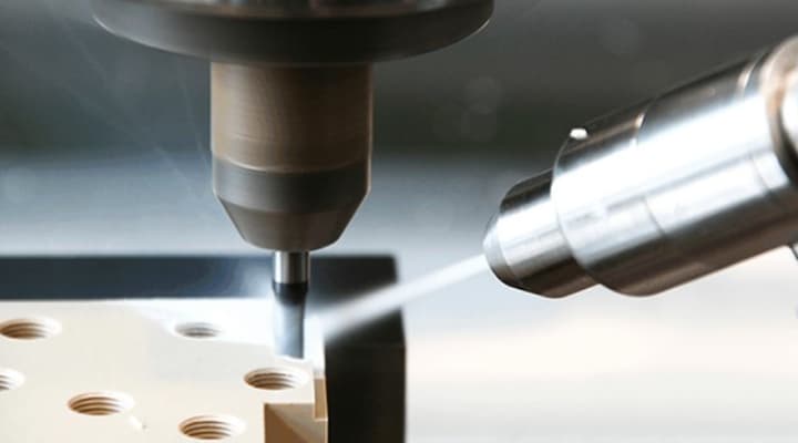 Close-up of CNC milling on a PEEK plastic part showing fine detail and precision cuts